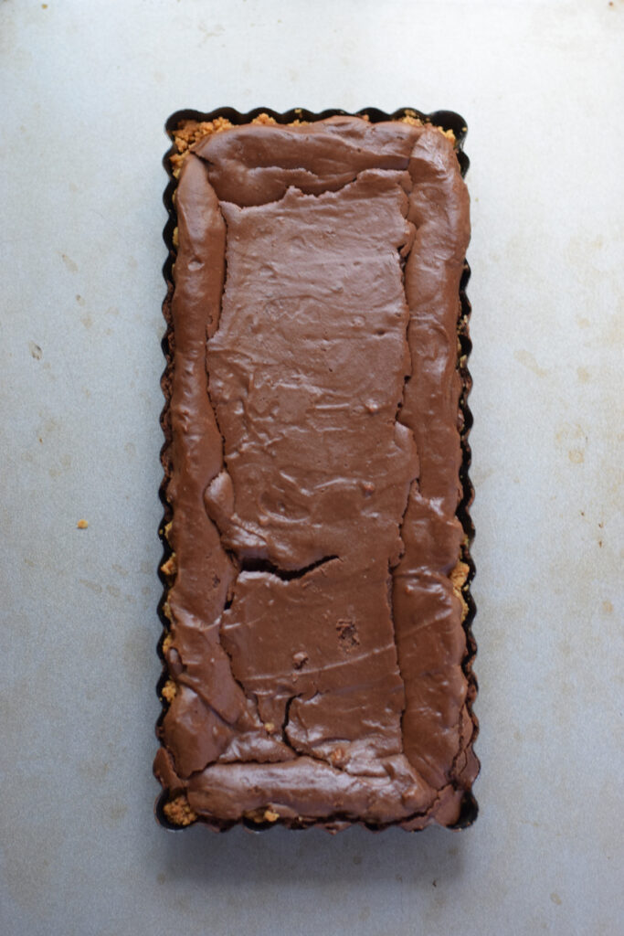 Baked chocolate cheesecake tarts in a tin.