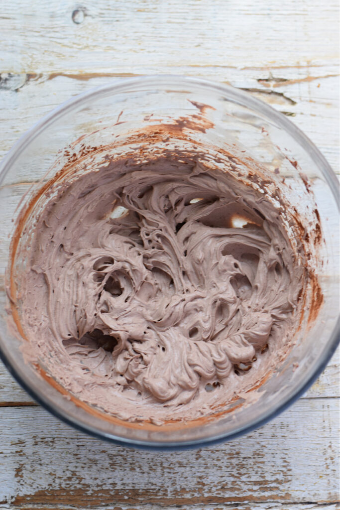 Chocolate whipped cream topping in a glass bowl.