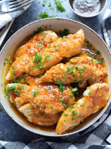 Honey garlic chicken tenders in a bowl.