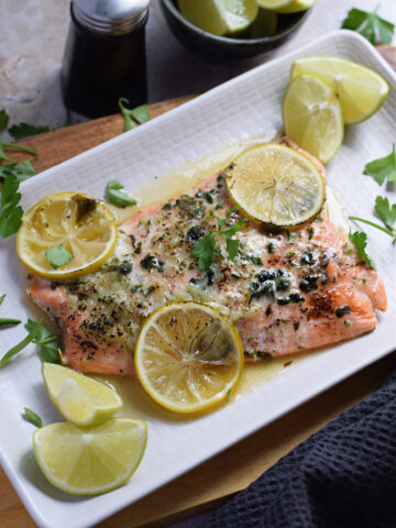 Baked honey lime salmon on a white plate.