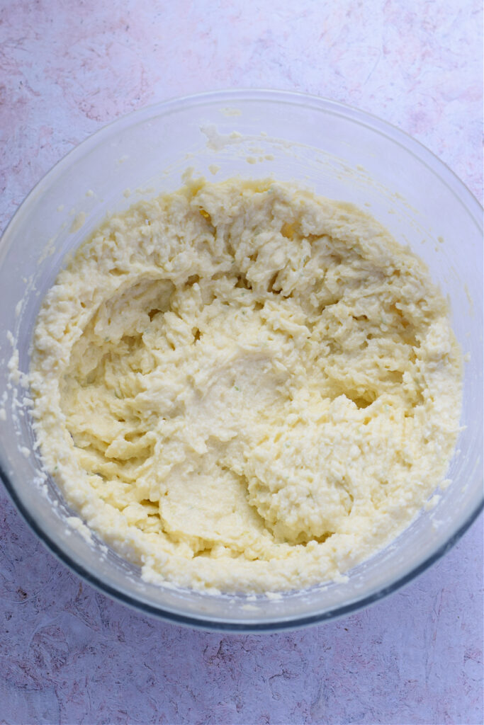 Making ricotta coconut lime cookie dough in a bowl.