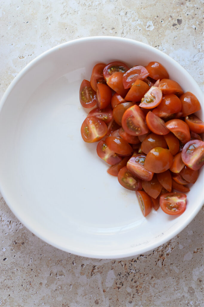 Chopped tomatoes in a white bowl.