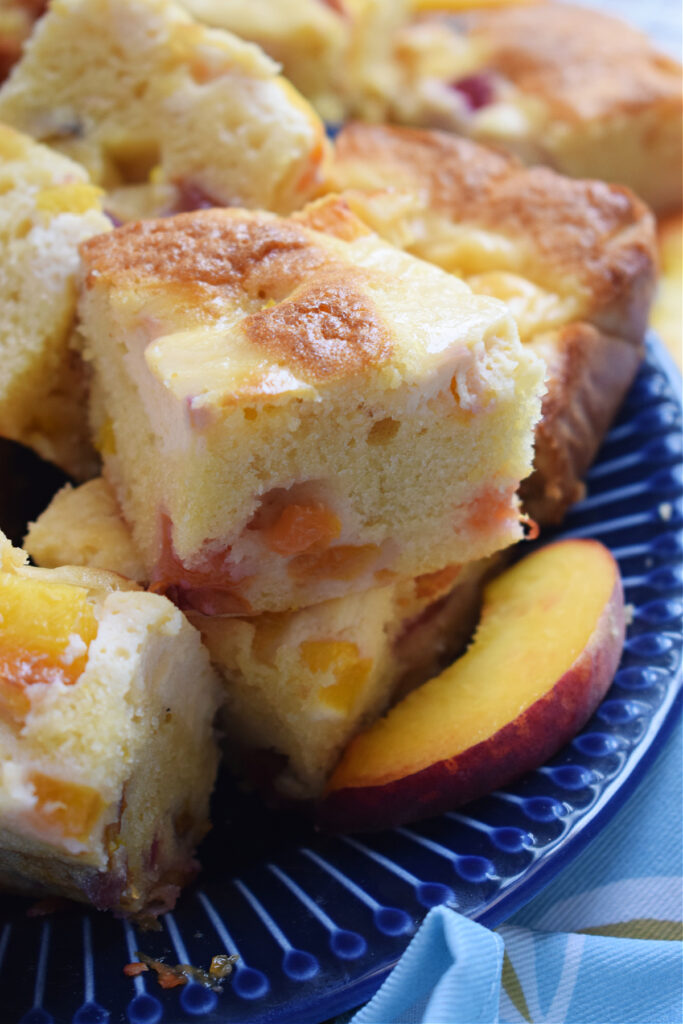 Close up of cream cheese peach cake squares.