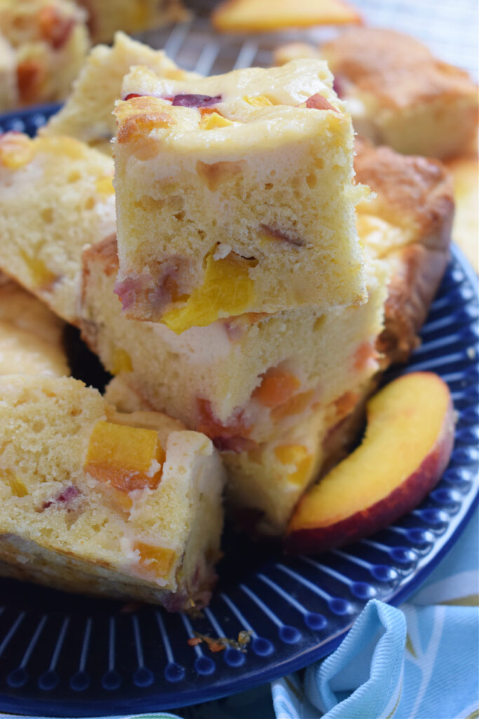 Close up of cream cheese peach cake squares.
