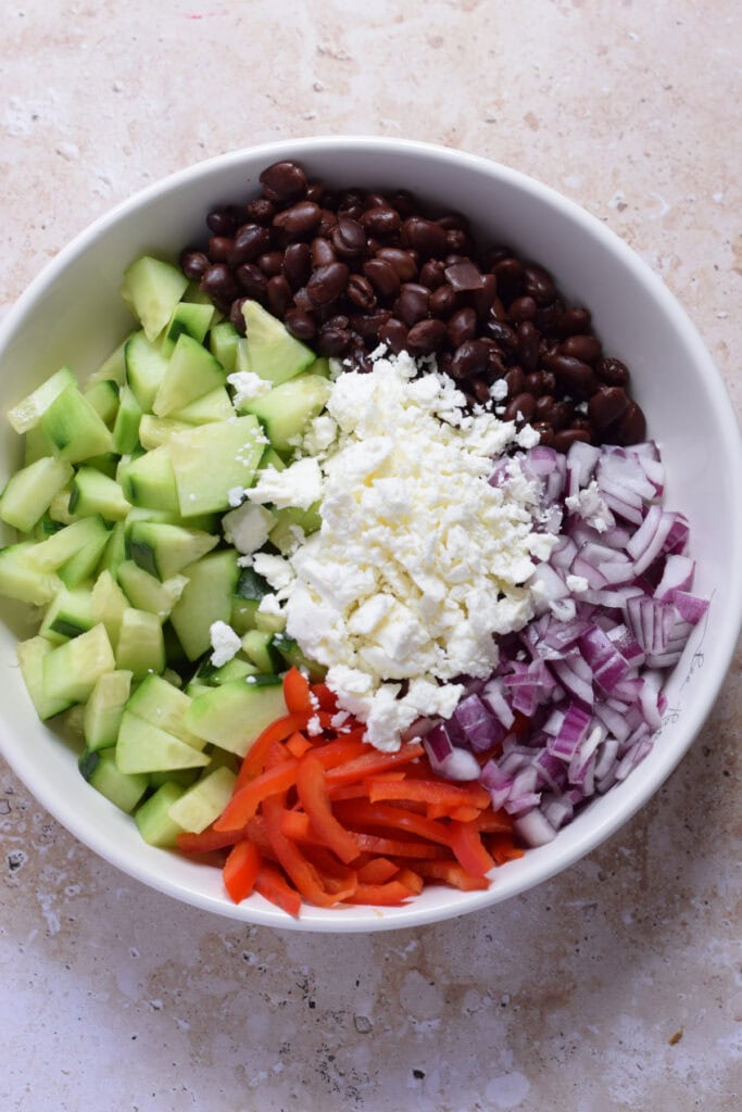 Salad ingredients in a white bowl.