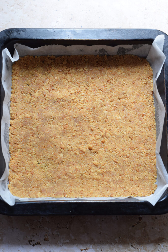 Cookie crumb base in a baking dish.