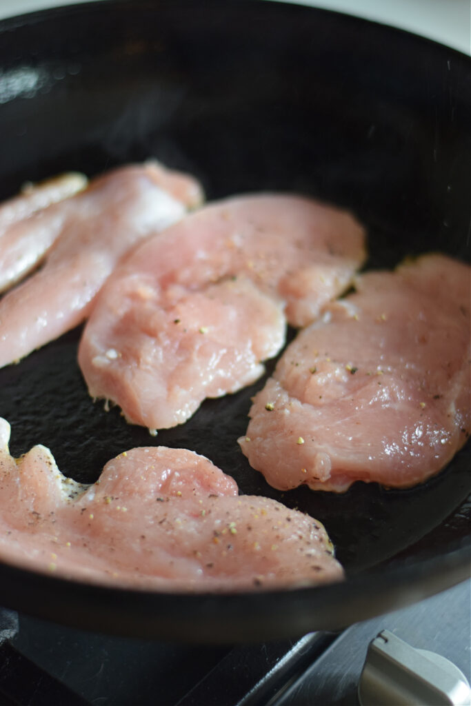 Cooking turkey cutlets in a skillet.