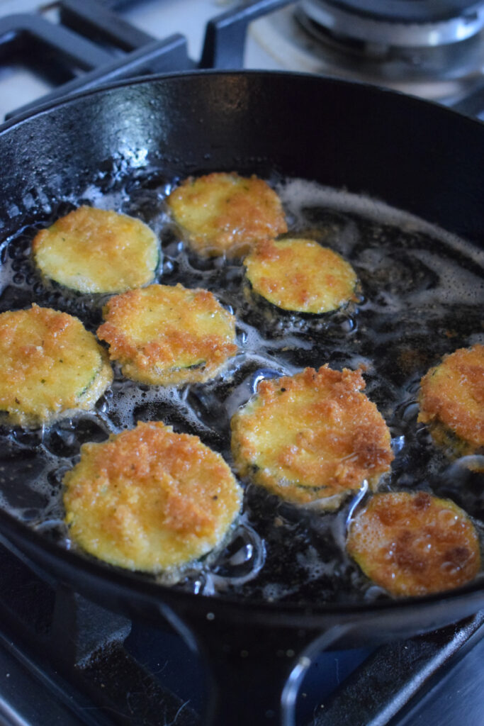 Cooking zucchini in a skillet.
