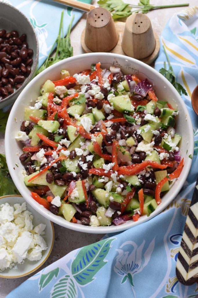 Black bean and cucumber salad in a white serving bowl.