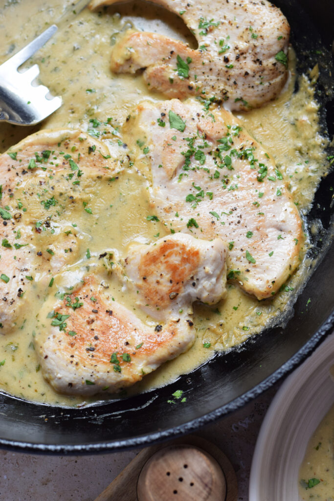 Close up of turkey cutlets with Dijon mustard.