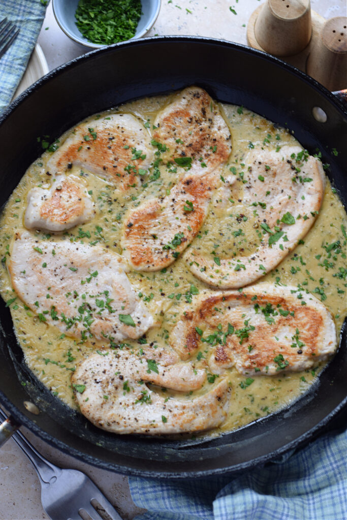 Creamy turkey cutlets in a sauce.