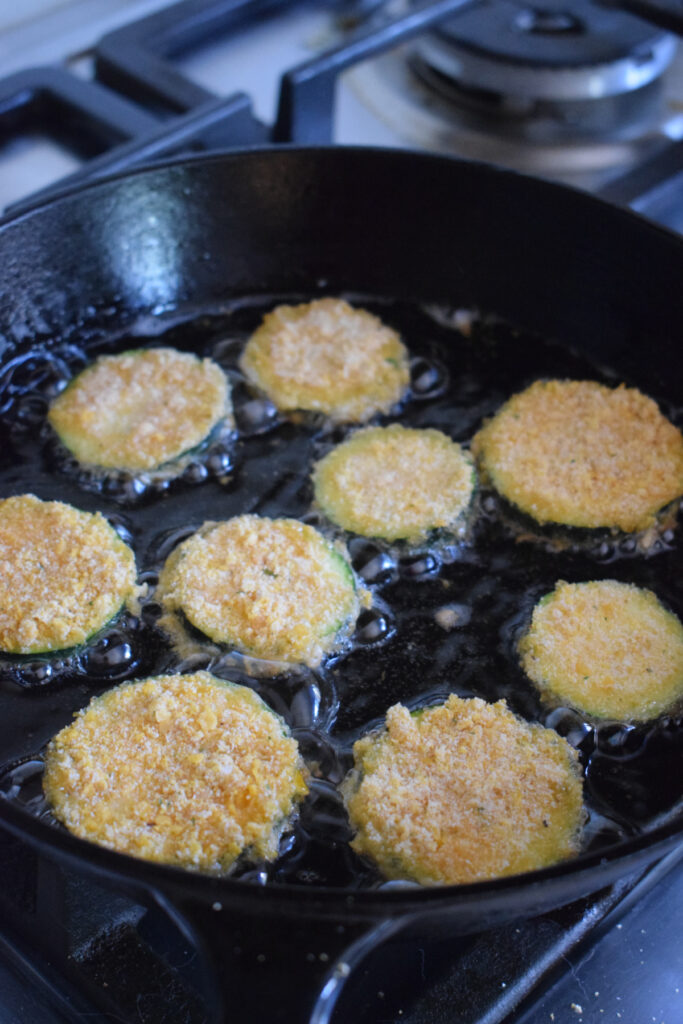 Frying zucchini in a skillet.