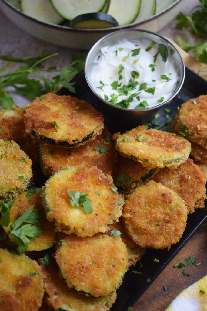 Zucchini on a plate with a dip.