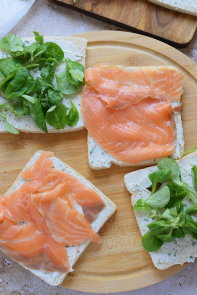 Making cream cheese sandwiches.