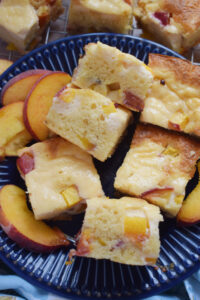 Peach cake squares on a plate.