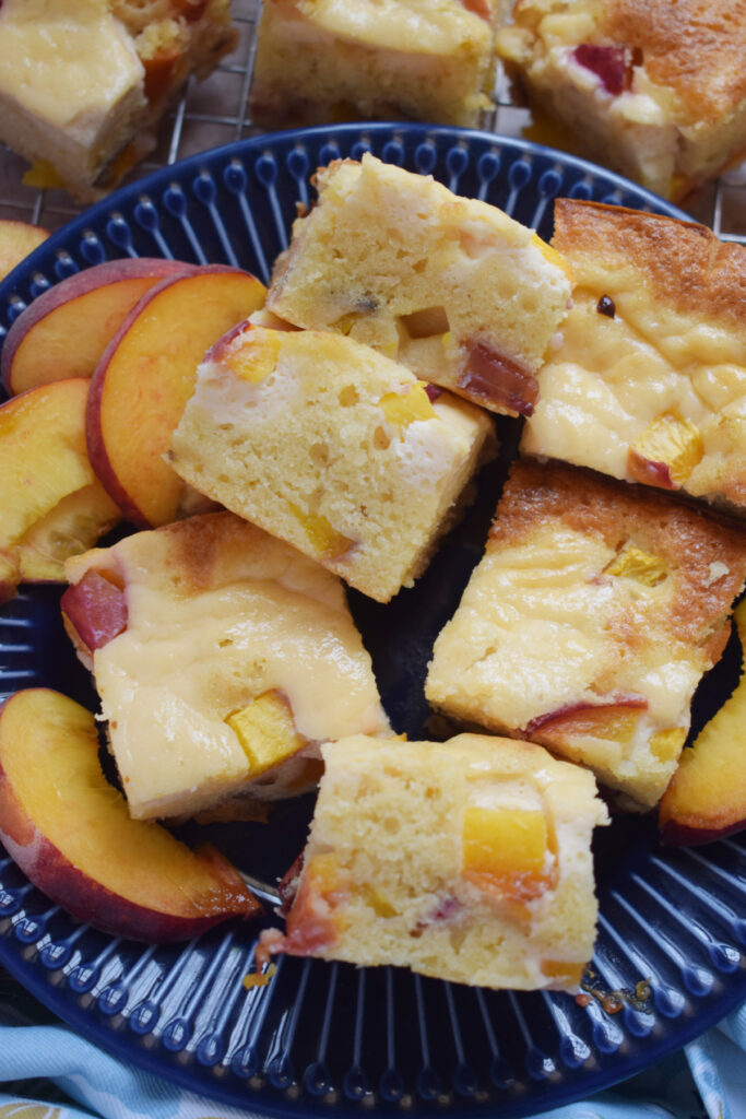 Peach cake squares on a plate.