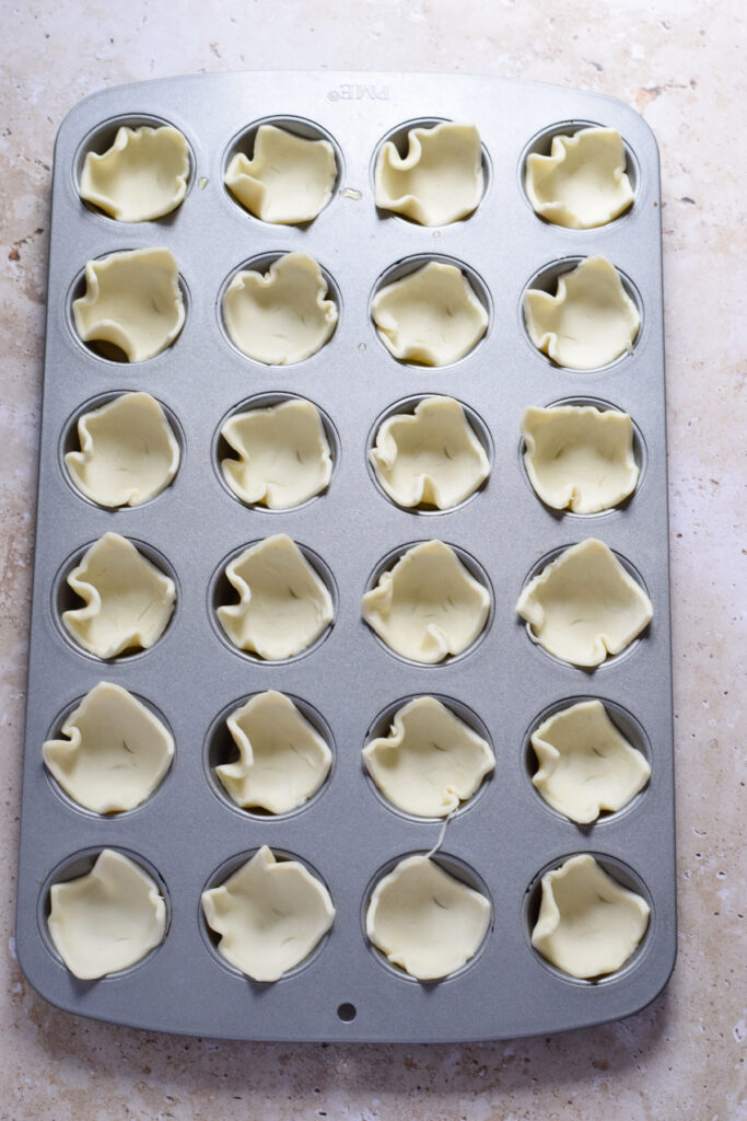 Muffin pan with puff pastry.