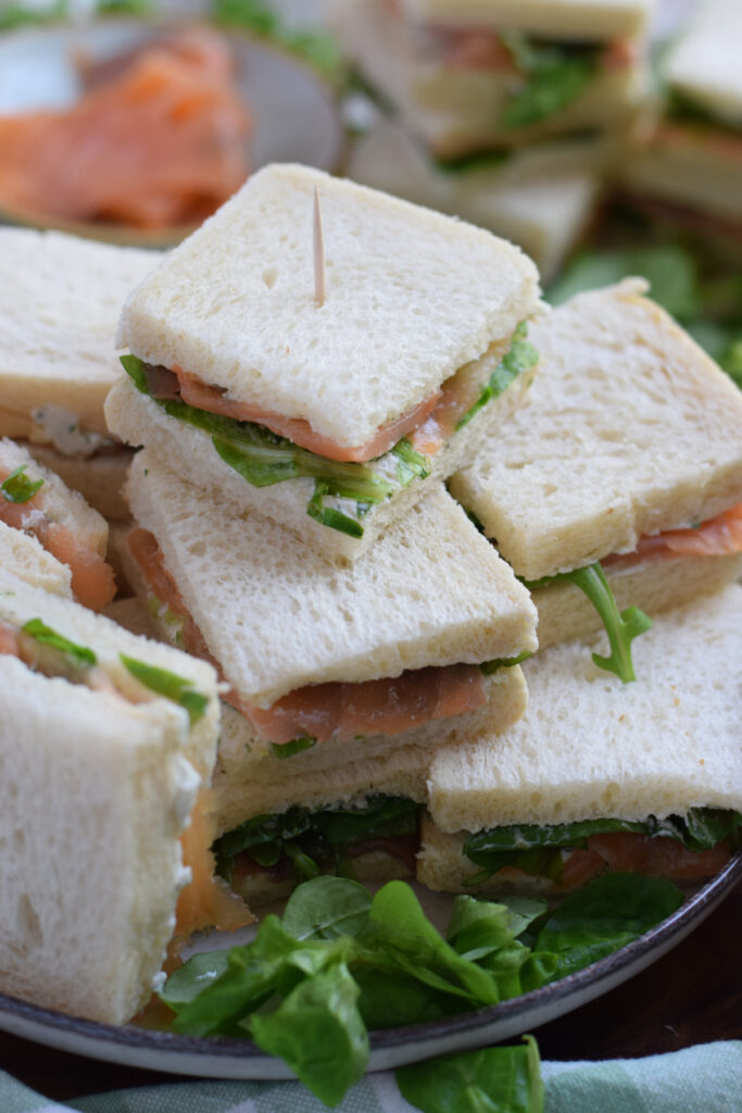 Smoked salmon sandwiches on a plate.