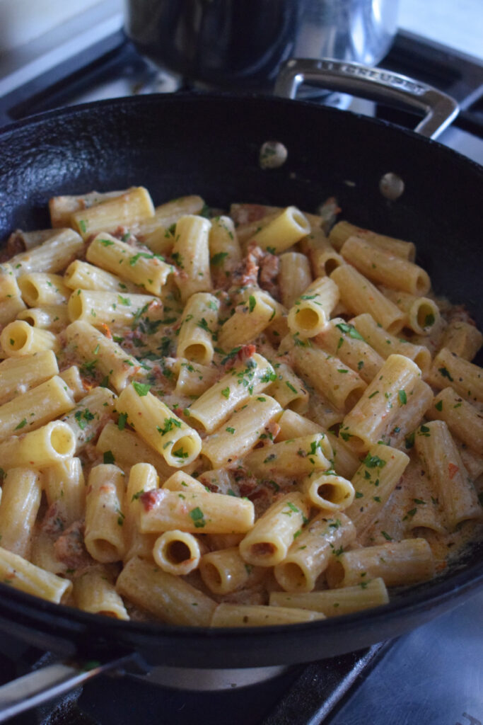 Penne pasta in a sauce.