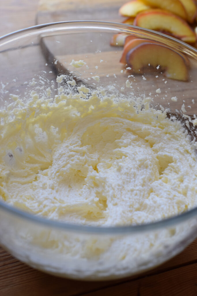 Vanilla cake batter in a glass bowl.
