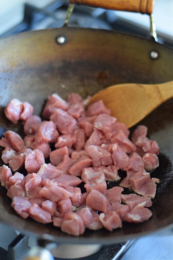 Cubed pork in a wok.