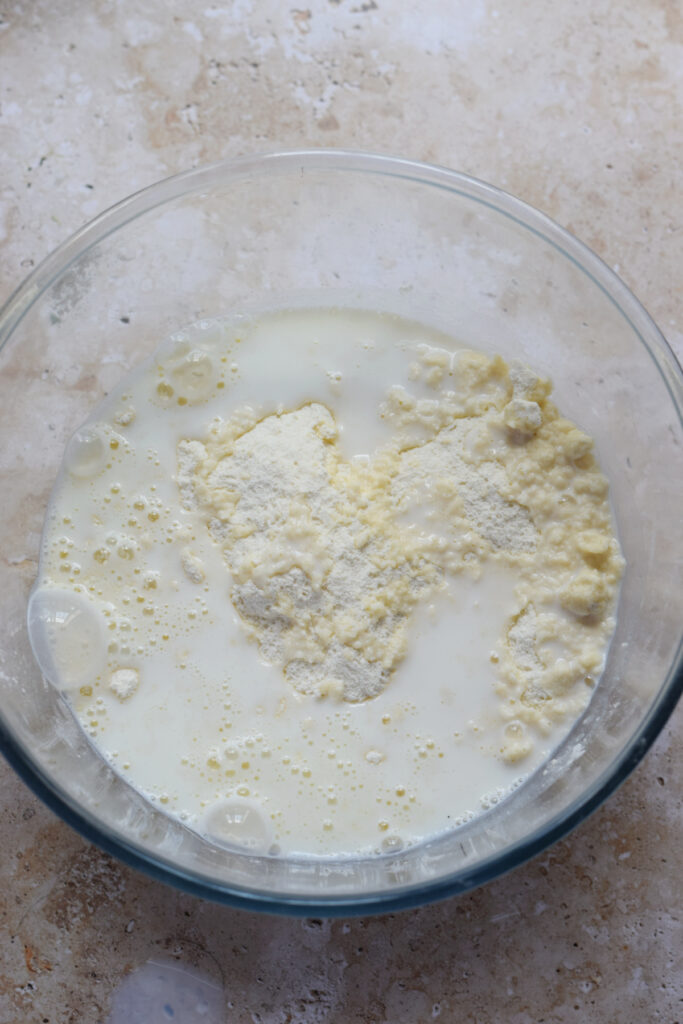 Adding milk to scone batter.