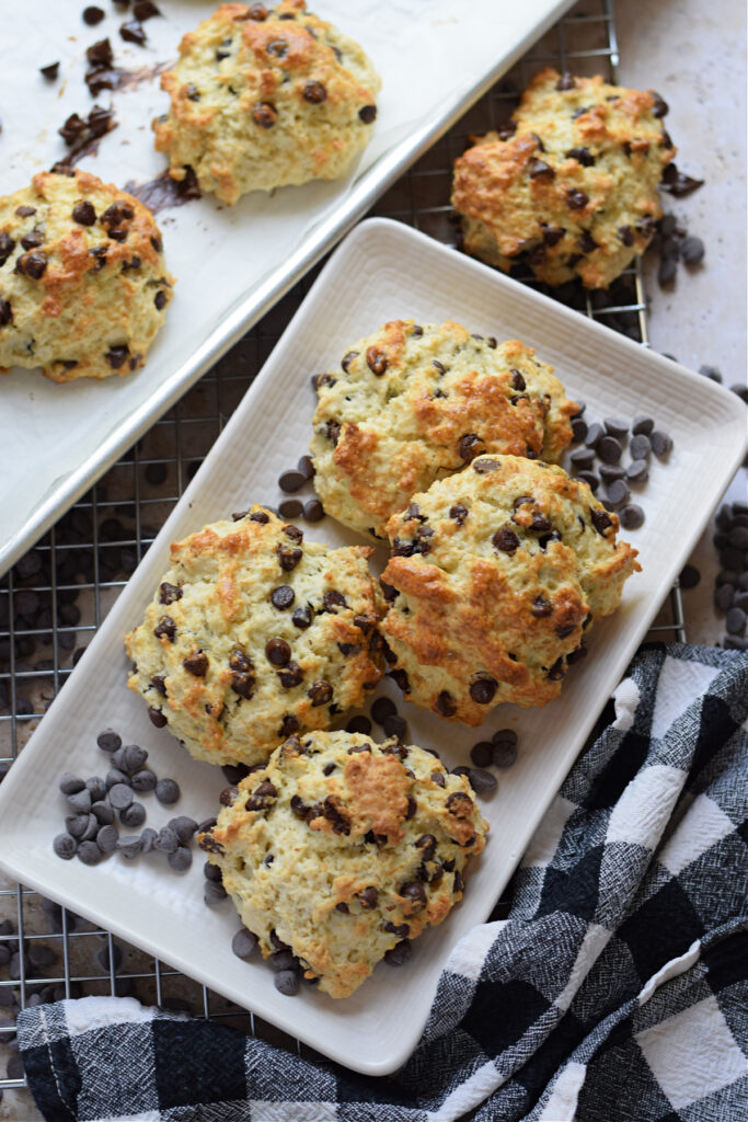 Chocolate chip scones on a white plate.