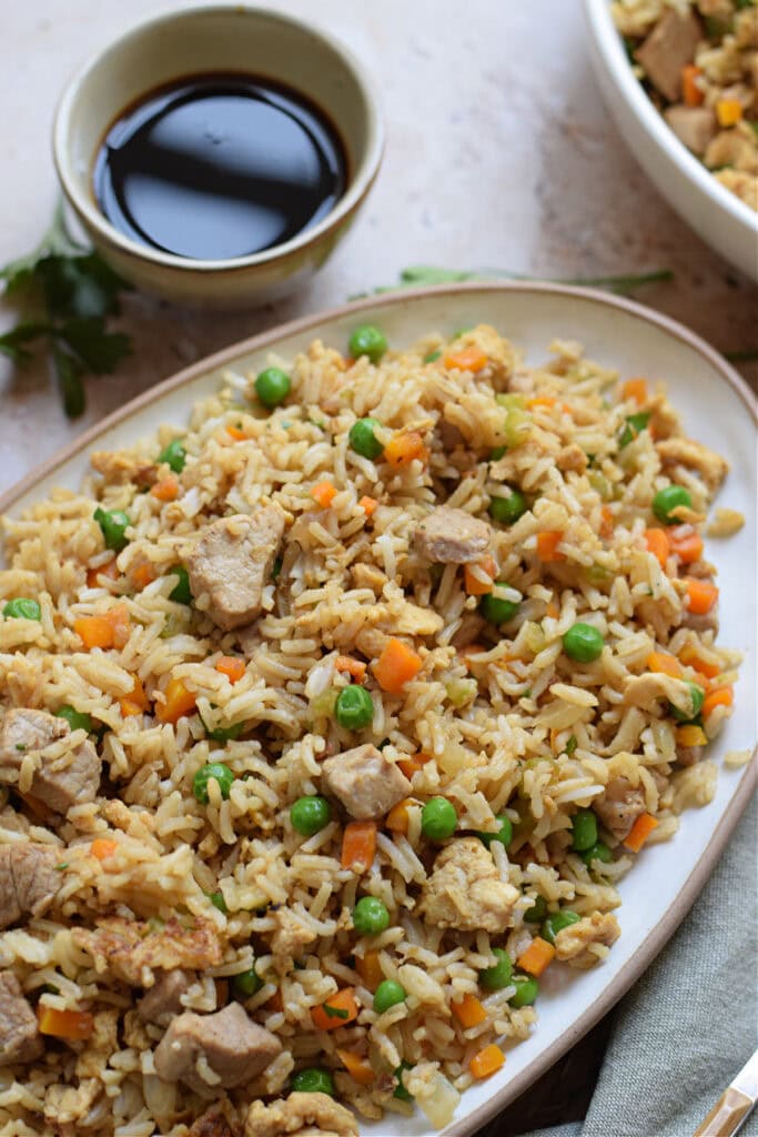 Close up of pork fried rice in a serving dish.
