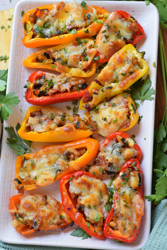 Stuffed mini peppers on a white plate.