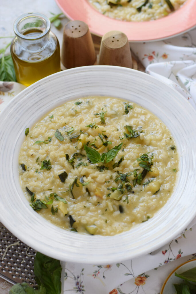 Close up of creamy risotto in a white bowl.
