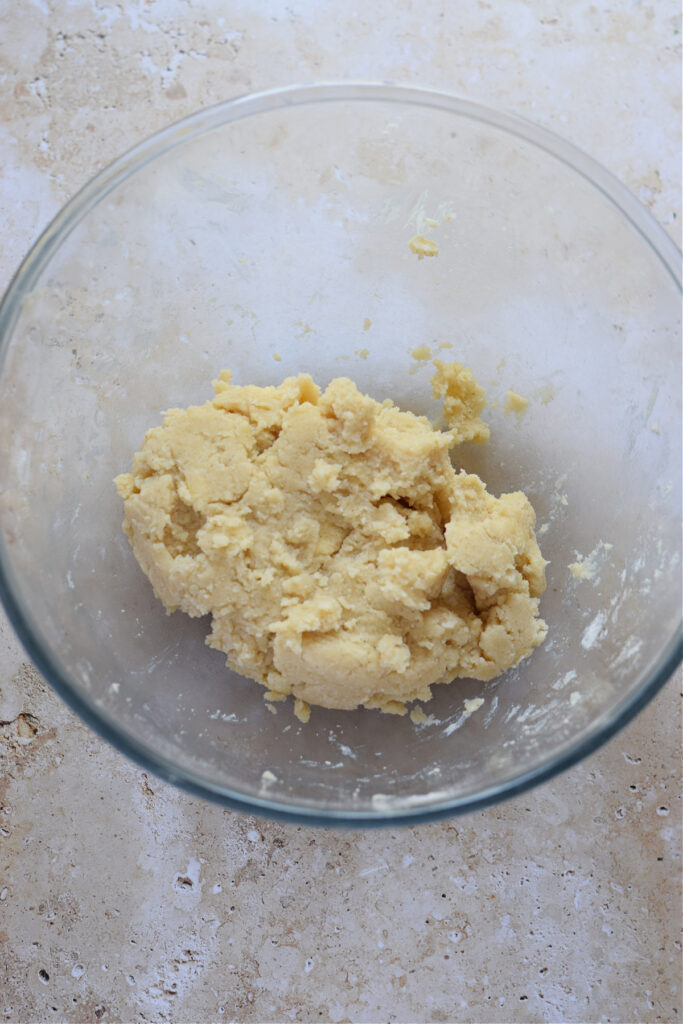Shortbread cookie dough in a glass bowl.