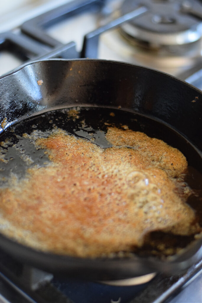 Cooking brown sugar and butter in a skillet.