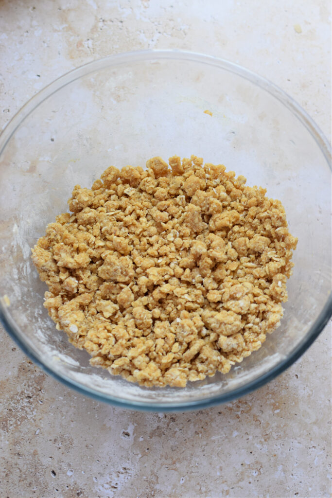 Making a crumble topping in a glass bowl.