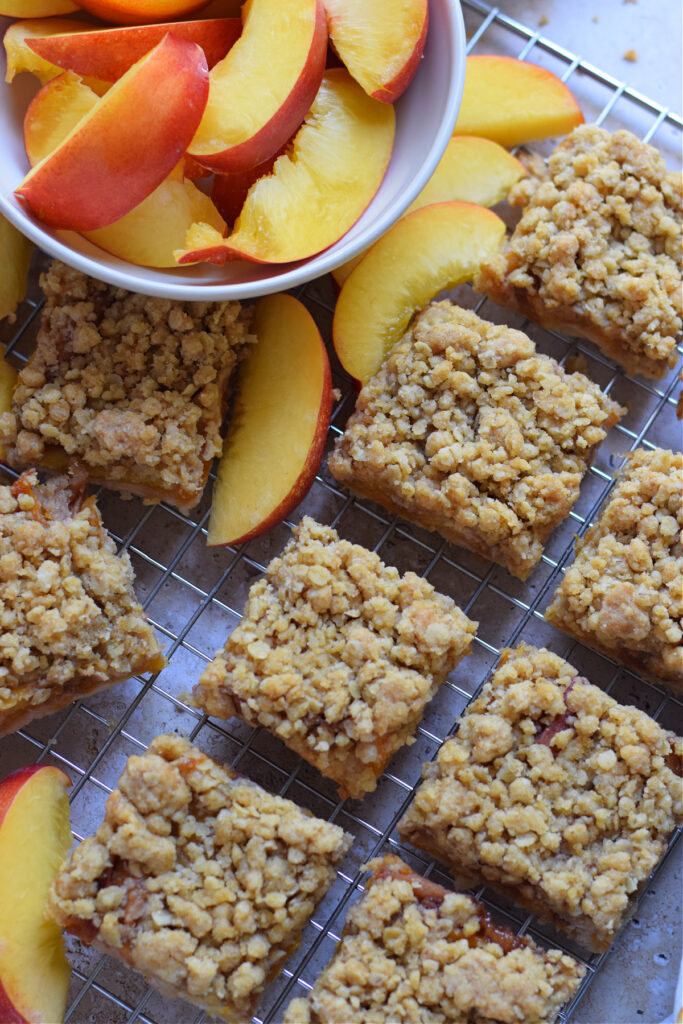 Peach crumble bars on a baking tray.