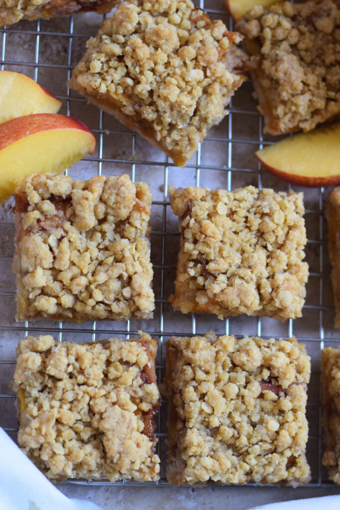 Peach crumble bars on a rack.