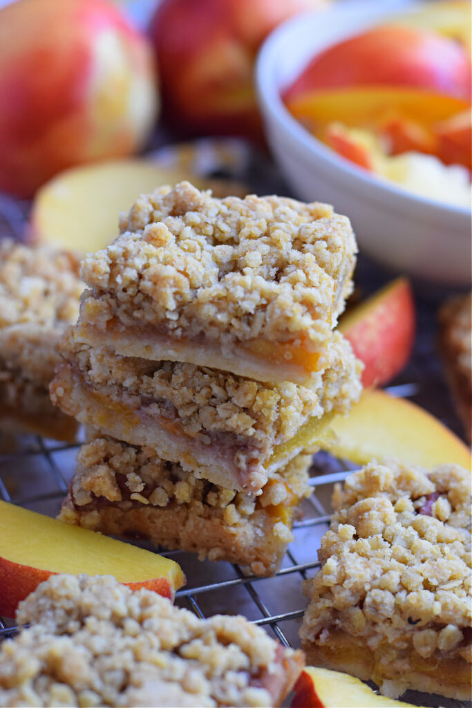 Peach crumble bars on a baking rack.