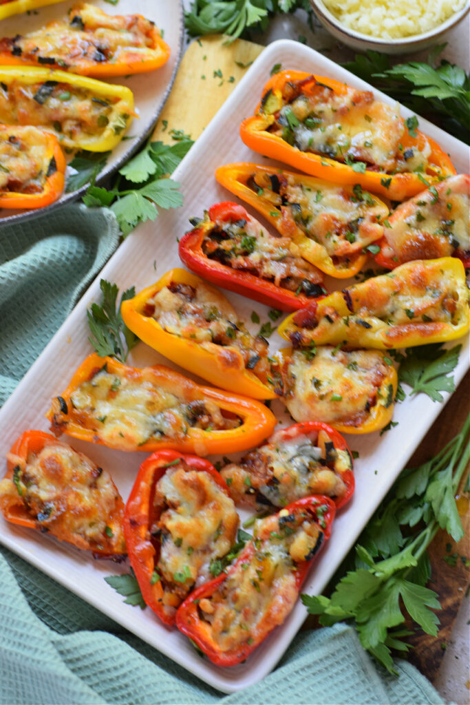 Red and yellow mini peppers stuffed with vegetables and cheese.
