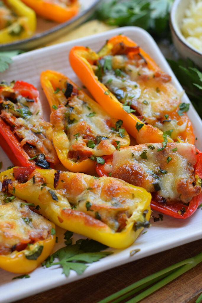 Close up of mini peppers stuffed with vegetables and cheese.