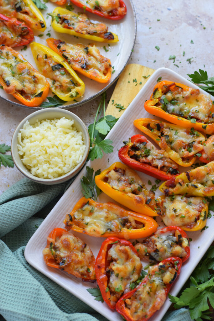 Stuffed mini peppers on a white plate.