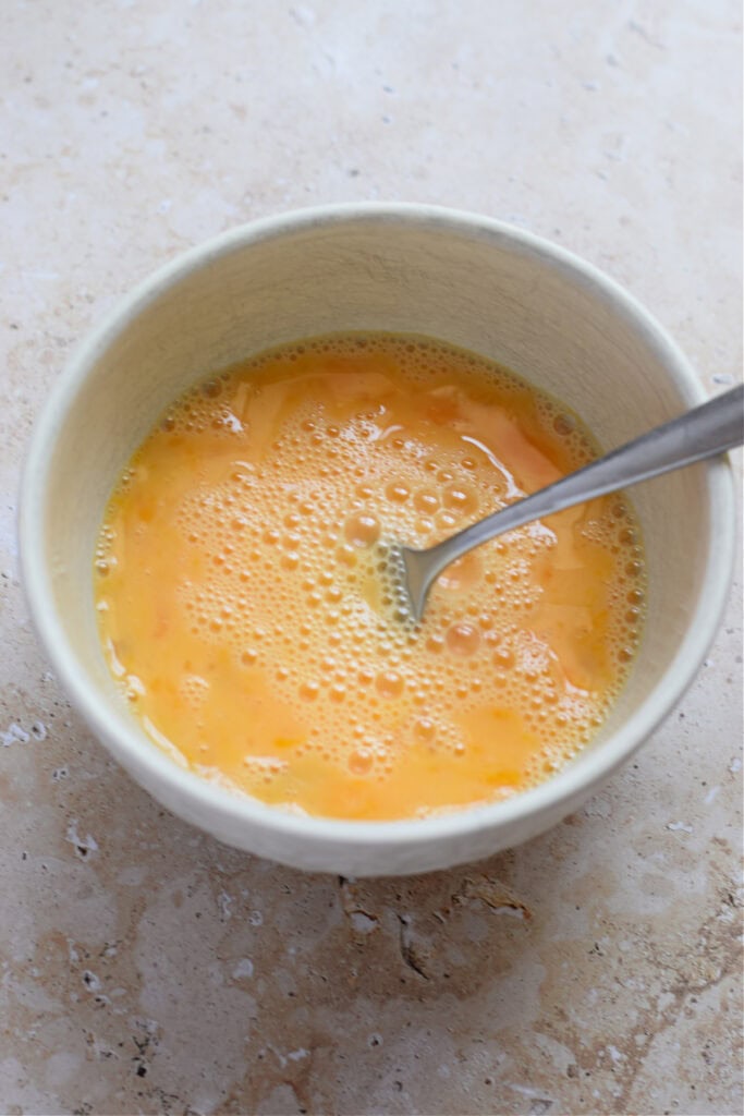 Whisked eggs in a bowl.