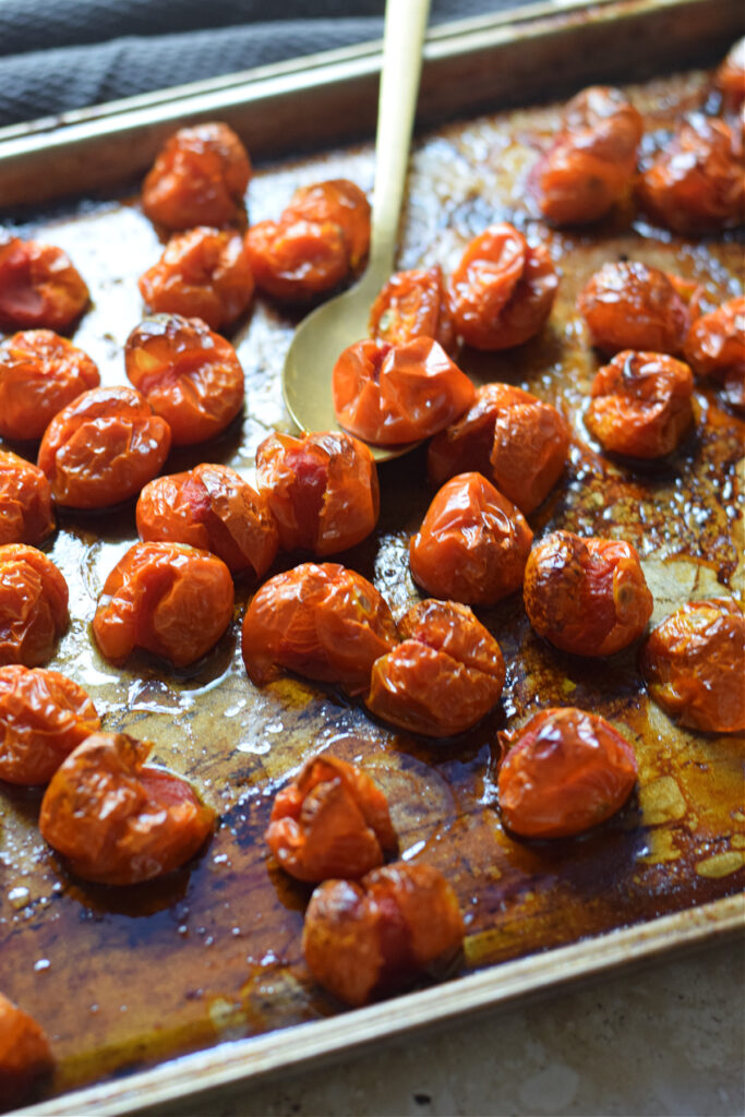 Close up of roasted cherry tomatoes on a tray.
