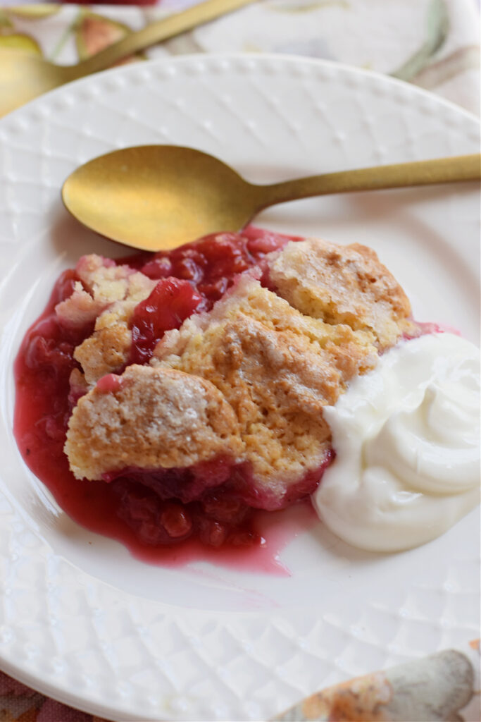 Close up of raspberry cobbler on a white plate.