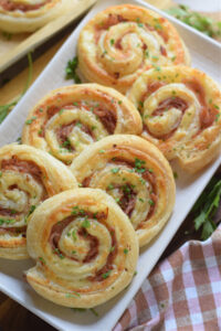 Puff pastry pinwheels on a white plate.