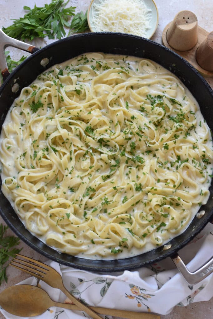 Creamy garlic pasta in a skillet.