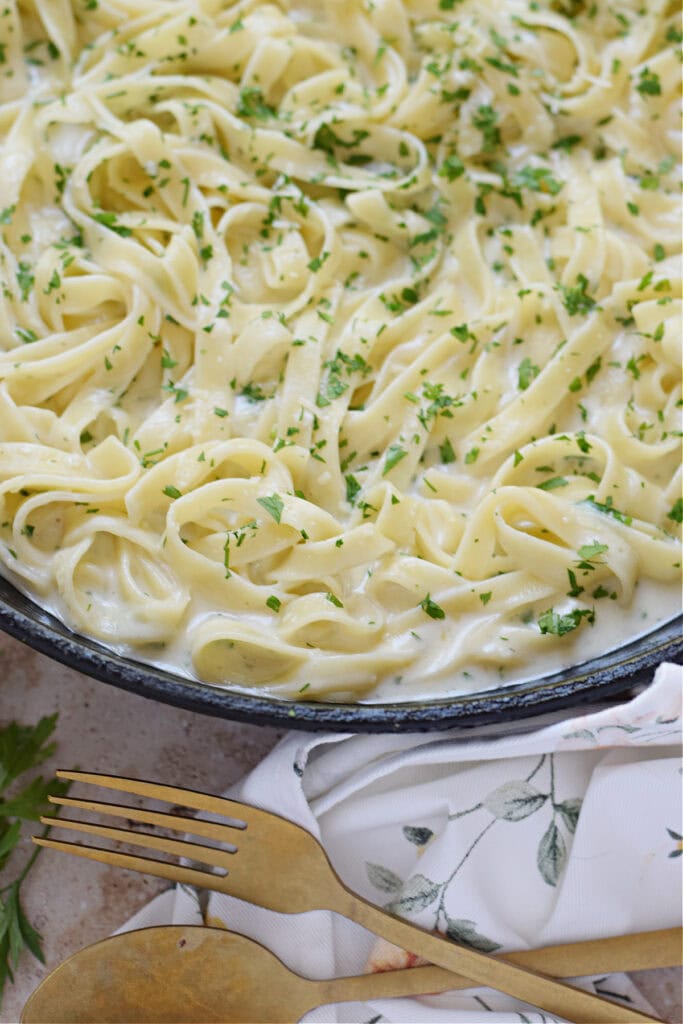 Creamy garlic parmesan pasta in a skillet.
