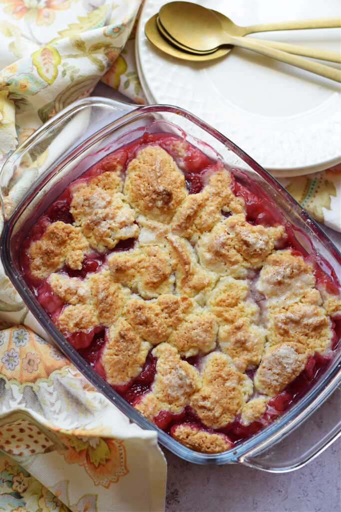 Fresh raspberry cobbler in a glass dish.