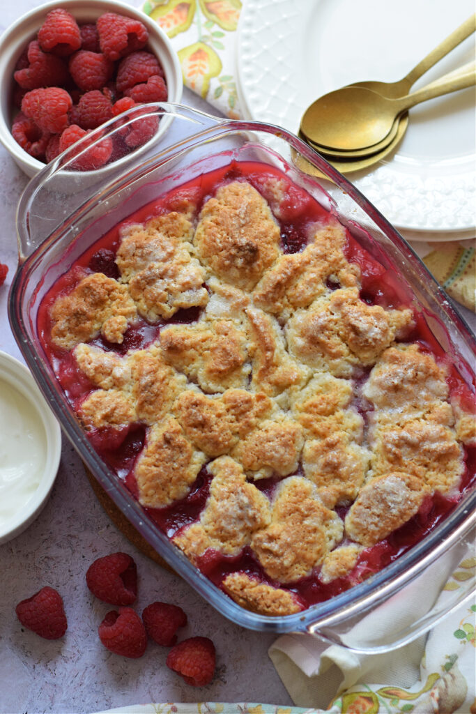 Raspberry cobbler in a glass dish.
