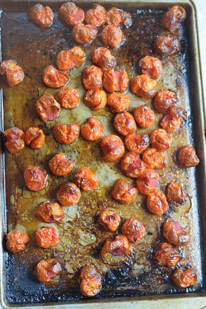 Roasted cherry tomatoes on a tray.