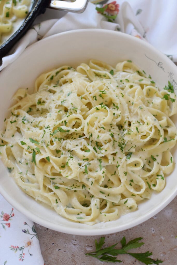 Creamy pasta in a white bowl.