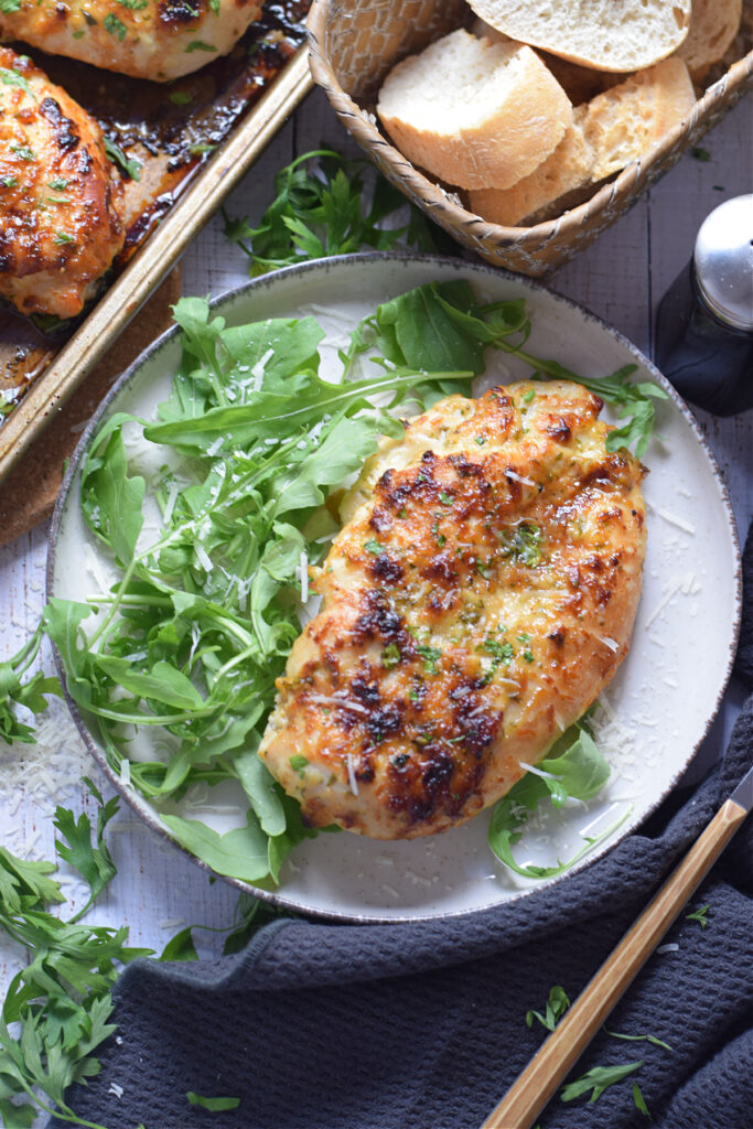 Honey garlic chicken breast on a white plate.